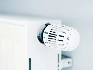 Thermostatic radiator valve fitted to a white home radiator